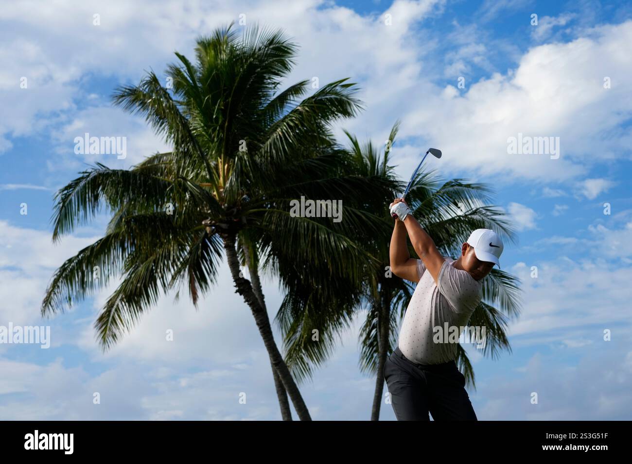 Tom Kim, of South Korea, hits on the 17th hole during the first round