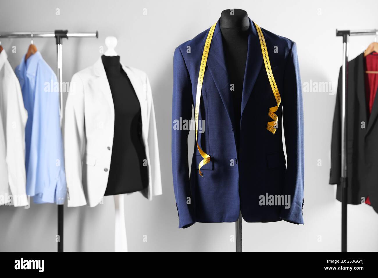 Male mannequin with jacket and measuring tape in tailor shop Stock ...
