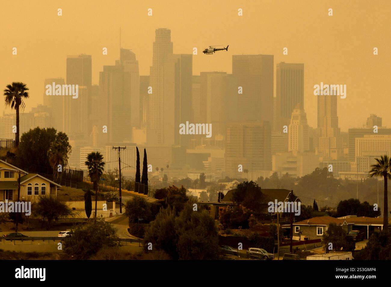 The sky is filled with smoke from multiple wildfires around the city