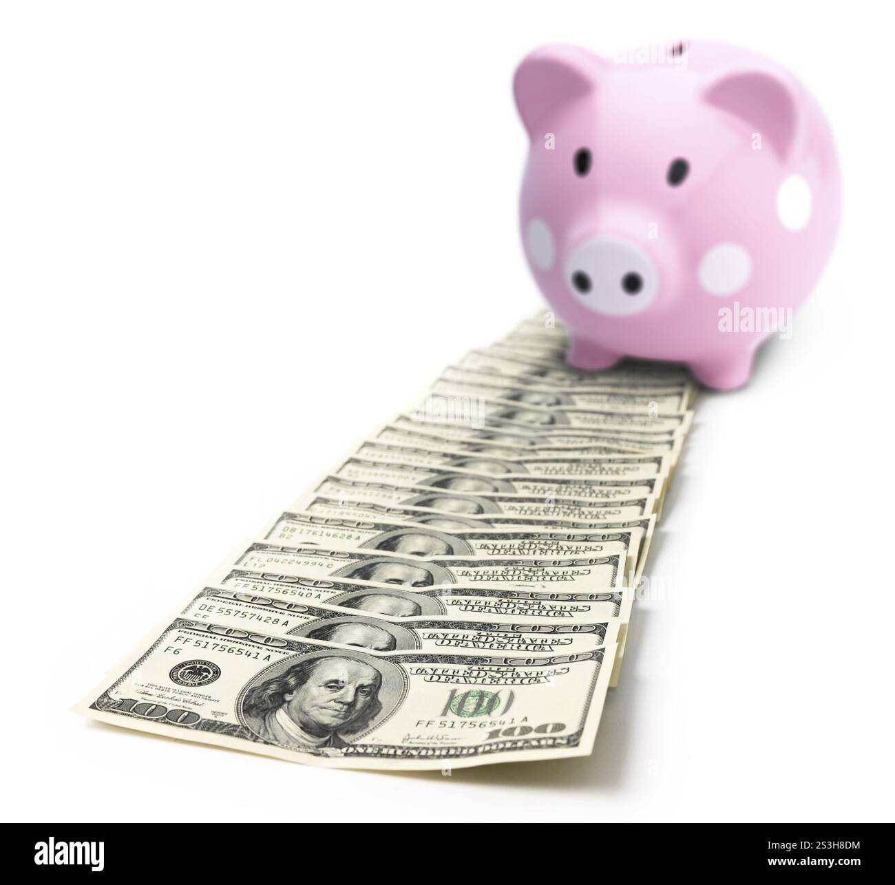Pink cute piggy bank on a pile of money isolated on white background ...