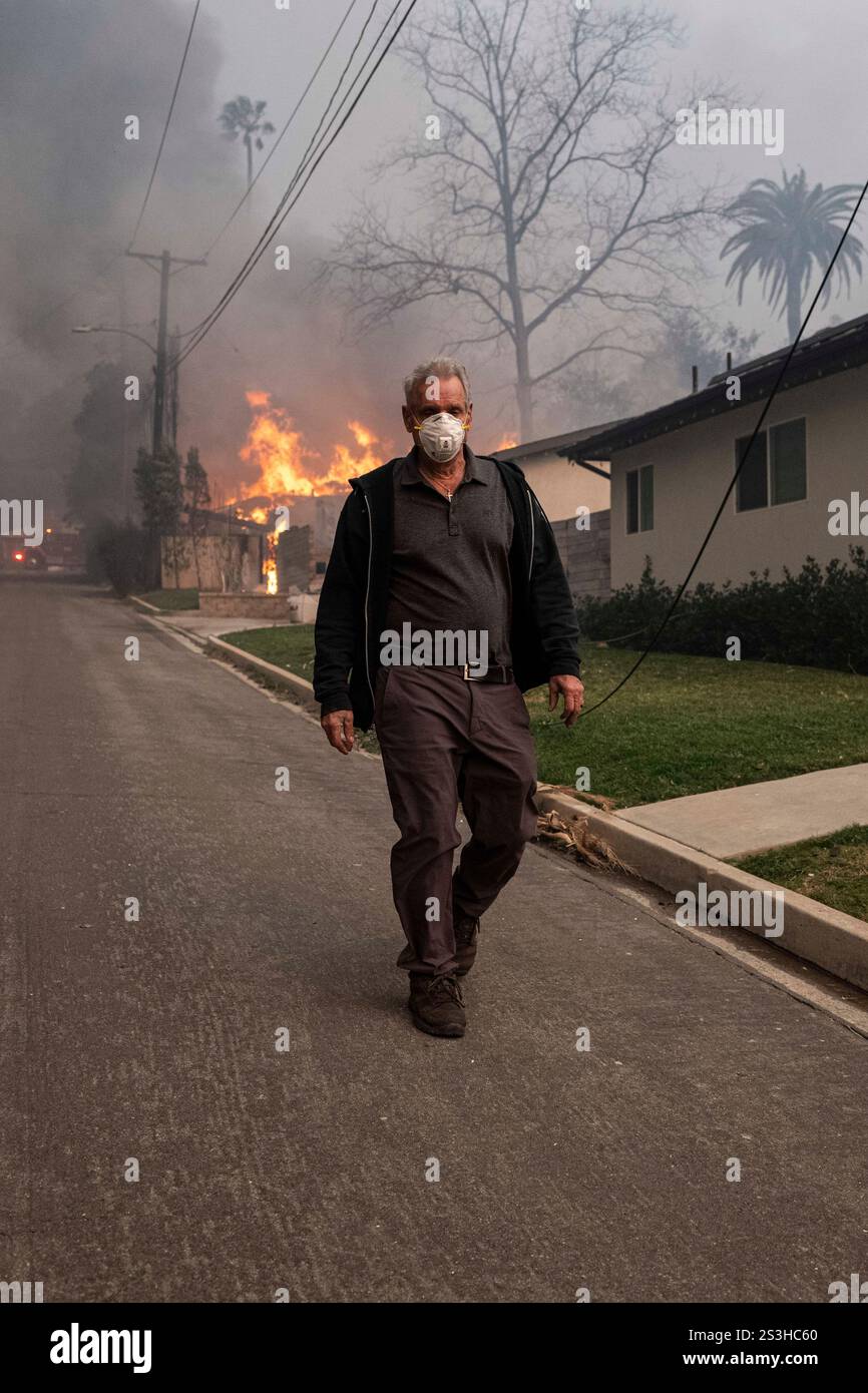 Altadena, United States. 08th Jan, 2025. An Altadena resident walks ...