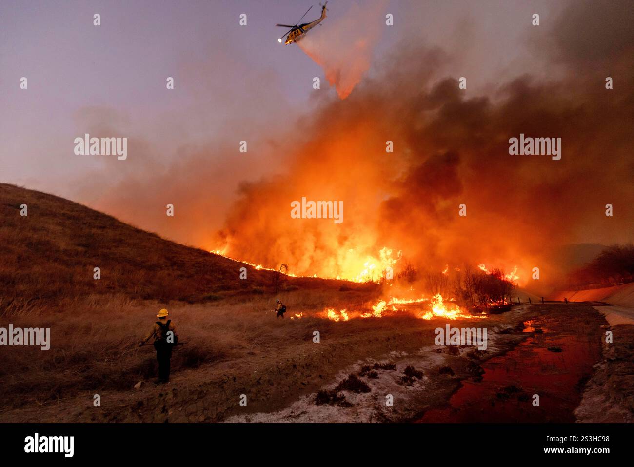 Fire crews battle the Fire in the West Hills section of Los