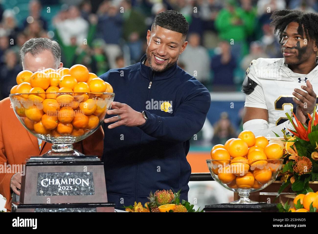 Notre Dame head coach Marcus Freeman touches the Orange Bowl trophy at