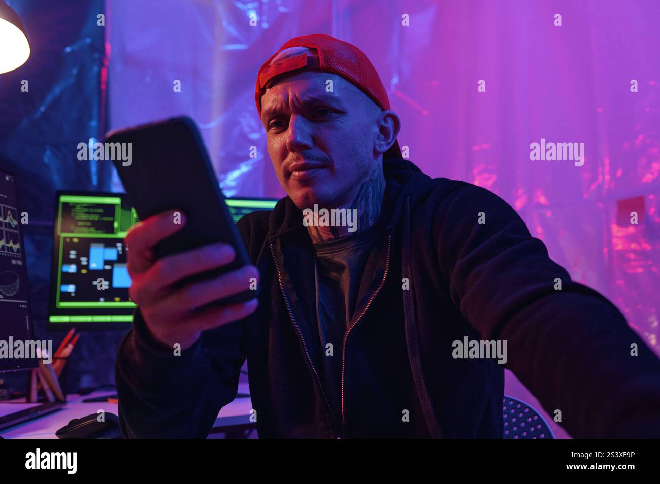 IT Worker Using His Smartphone At Work Stock Photo