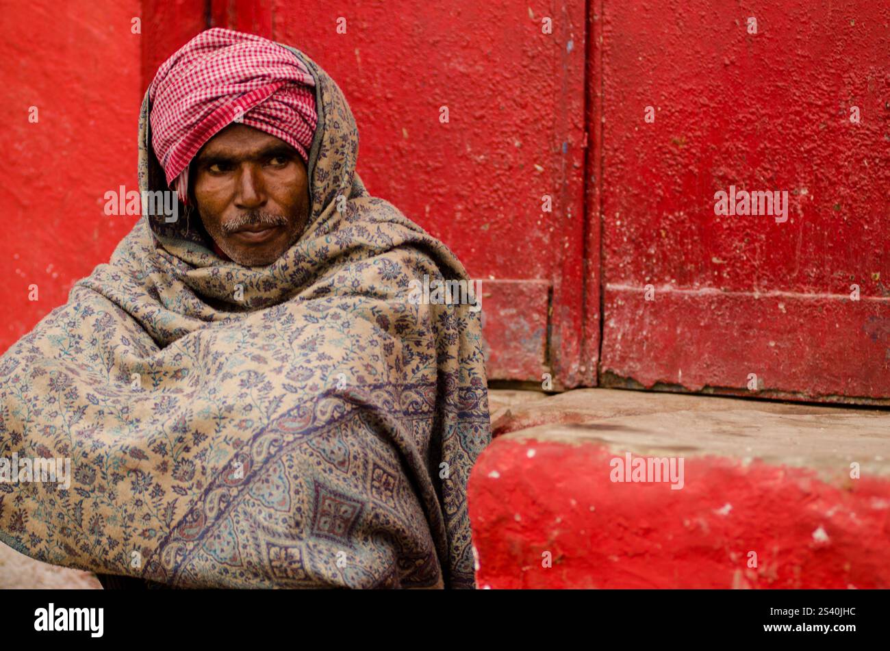 Elderly man in traditional attire at a vibrant cultural festival in ...