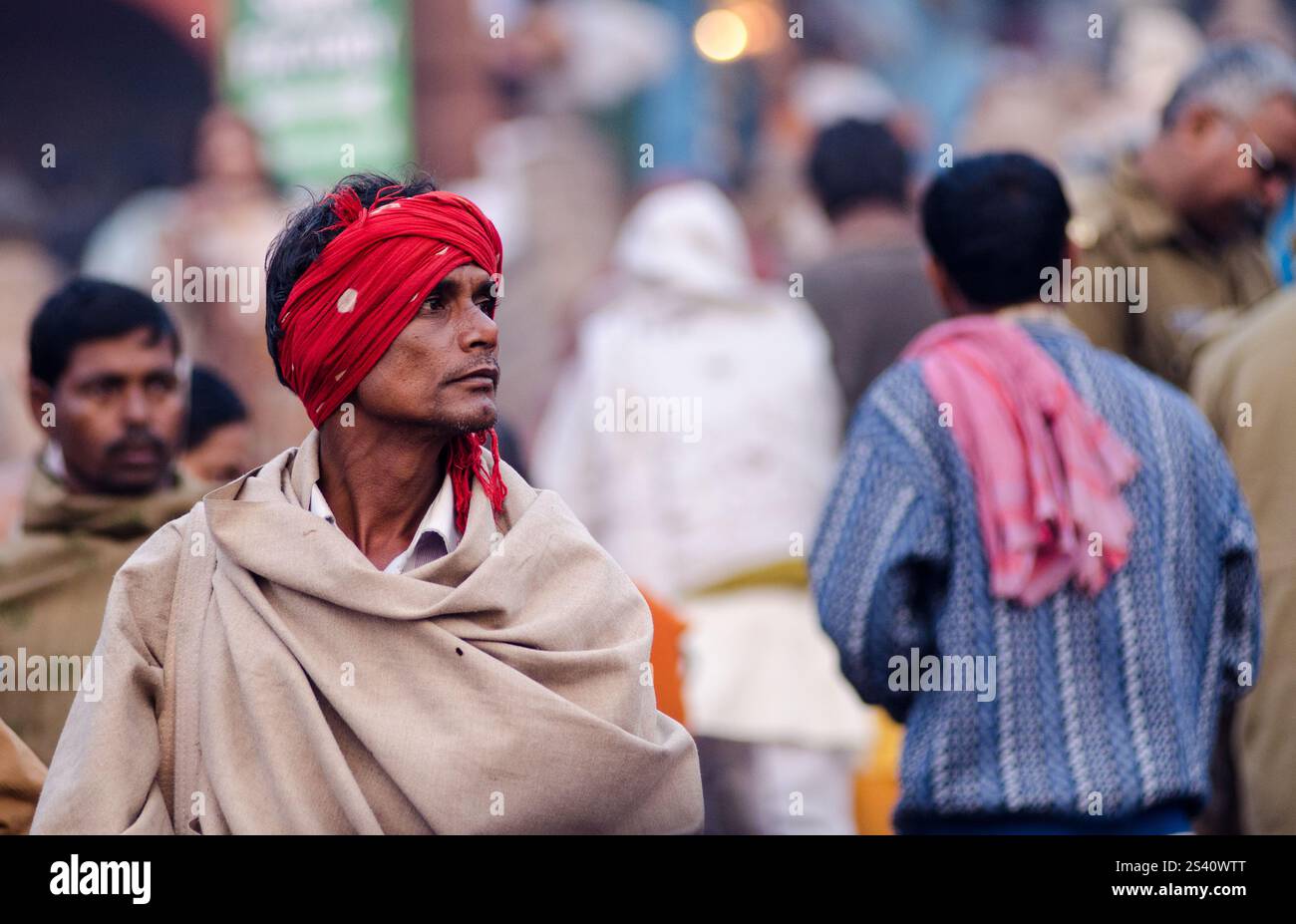 Elderly man in traditional attire at a vibrant cultural festival in ...