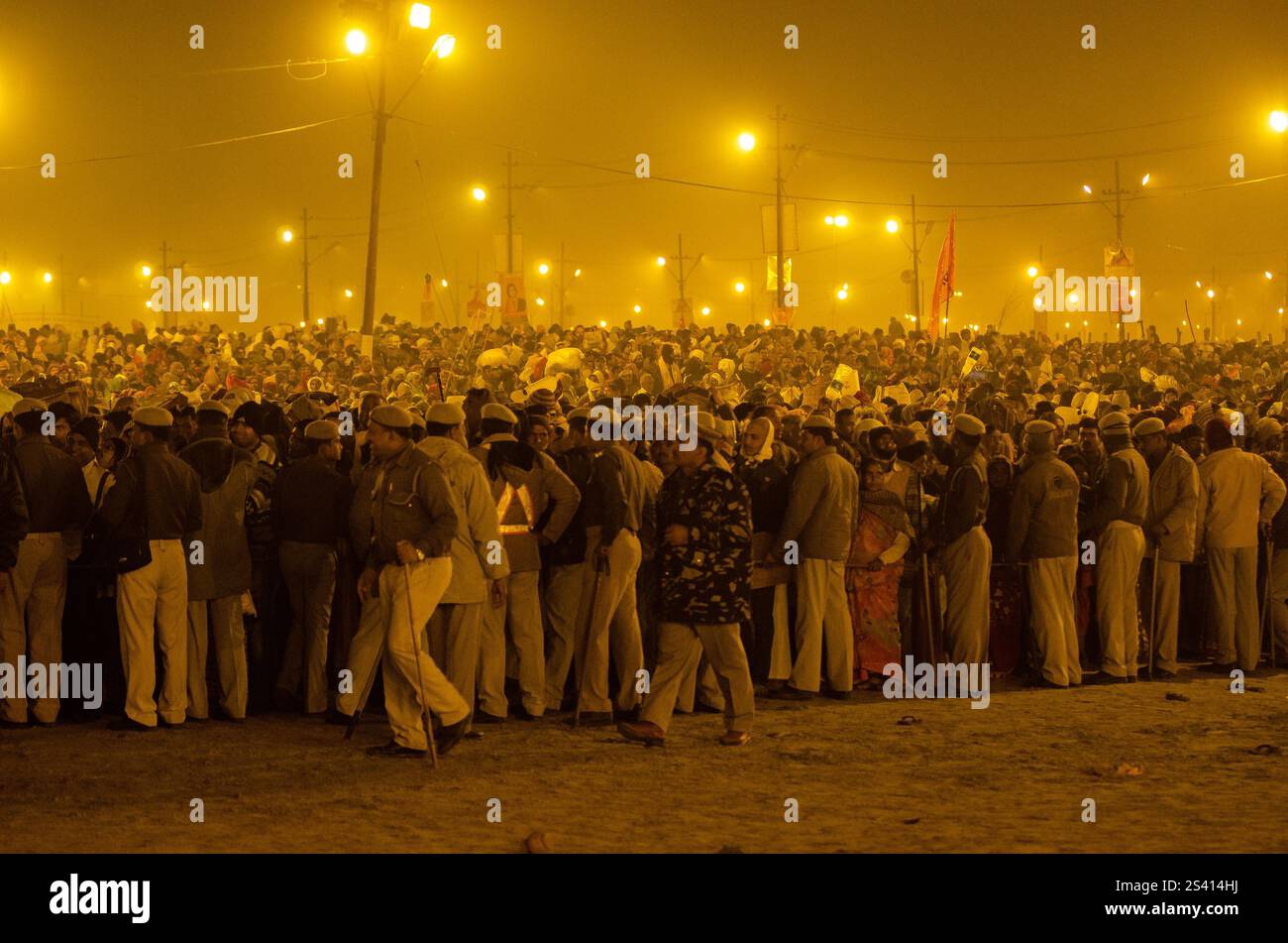 Crowd celebrating cultural festival at night with vibrant lights and traditional attire Stock Photo
