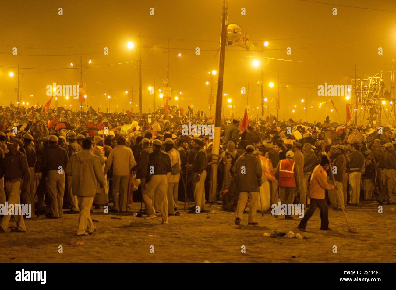 Crowd celebrating cultural festival at night with vibrant lights and traditional attire Stock Photo