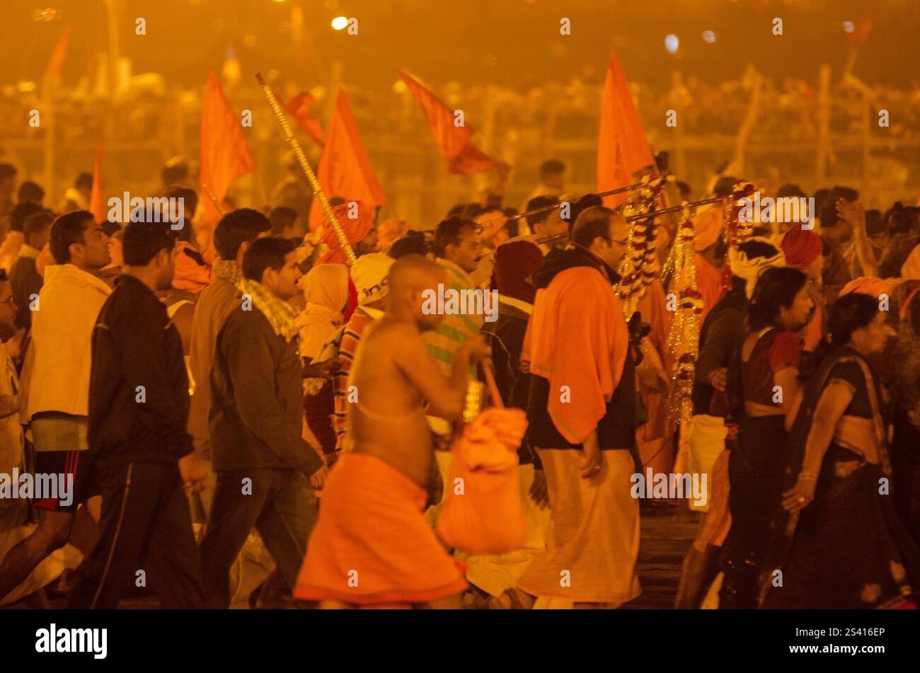 Crowd celebrating cultural festival at night with vibrant lights and traditional attire Stock Photo