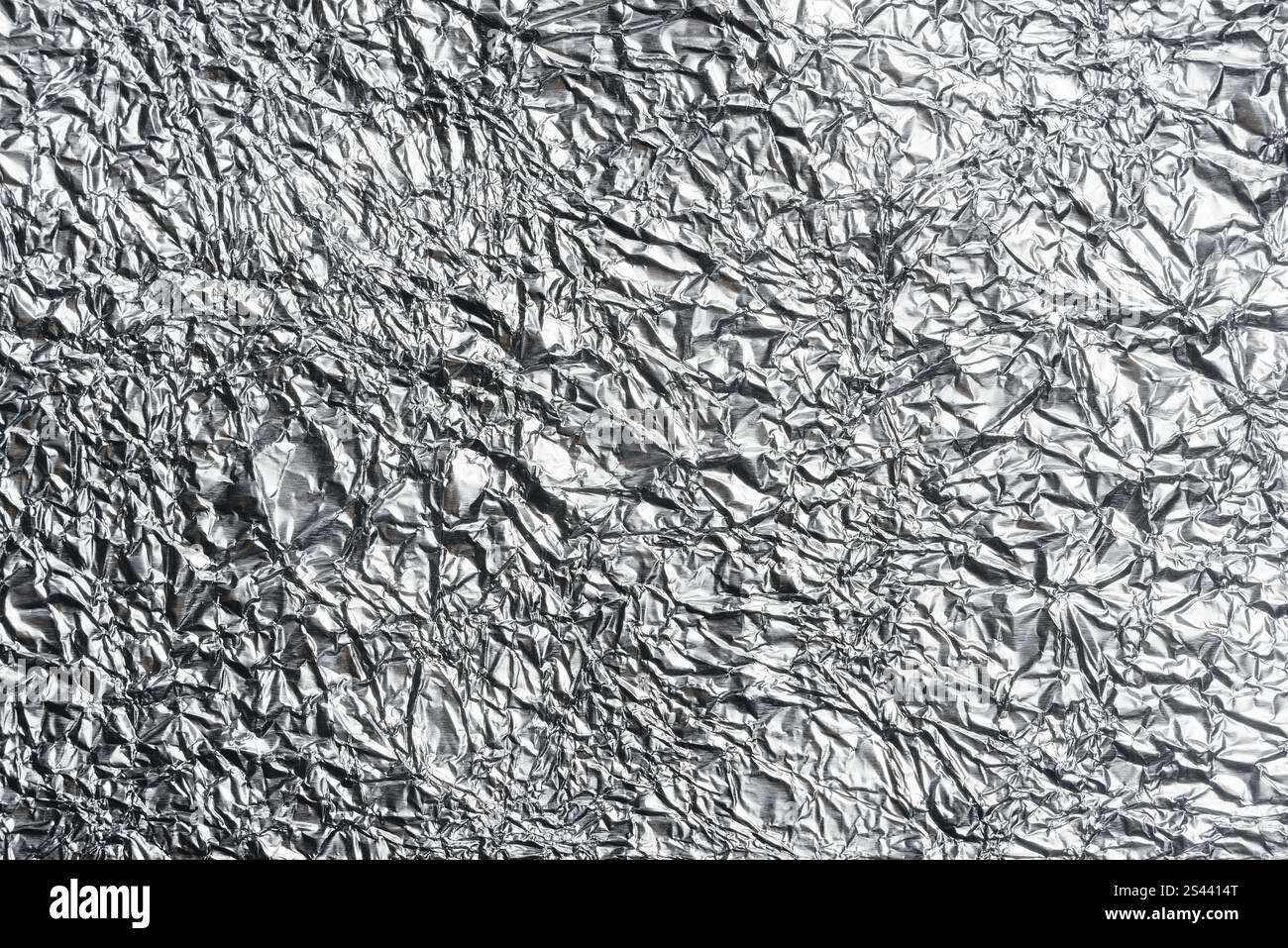 crumpled aluminum foil background or overlay Stock Photo