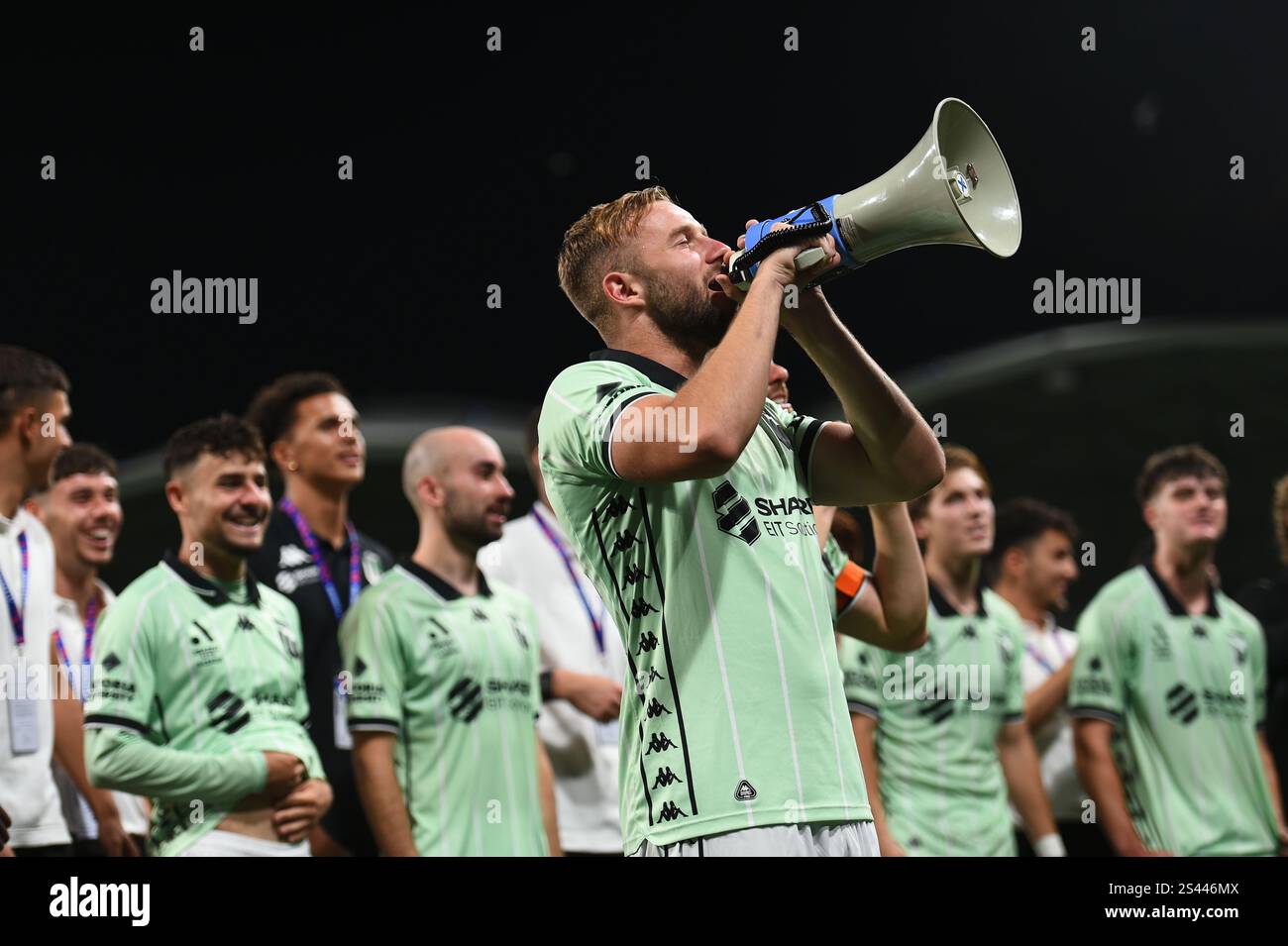 MELBOURNE, AUSTRALIA. 10th Jan 2025. Pictured: Western United forward Michael Ruhs chants into a megaphone and Ben Garuccio shouts towards the celebrating Western United travelling supporters after United secured 4-3 win at the end of the ISUZU A League Round 13 match, Melbourne Victory vs Western United at AAMI Park, Melbourne, Australia on 10th January 2025. Credit: Karl Phillipson / Alamy Live News Stock Photo