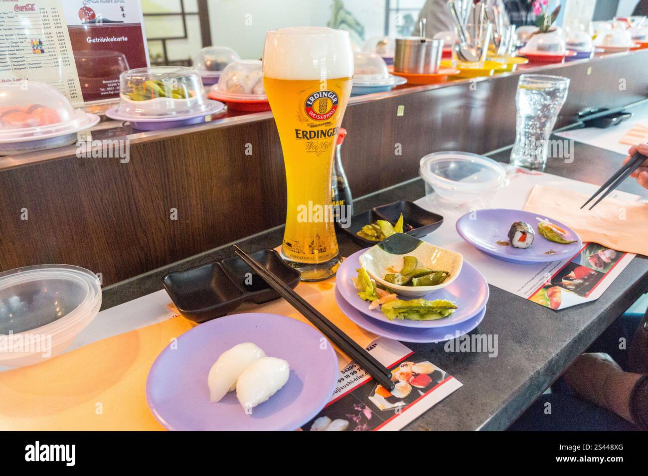 Erdinger weissbier white wheat beer and dishes on a conveyor belt, Fuji Sushi Bar Trier, Rheinland-Pfalz, Germany Stock Photo