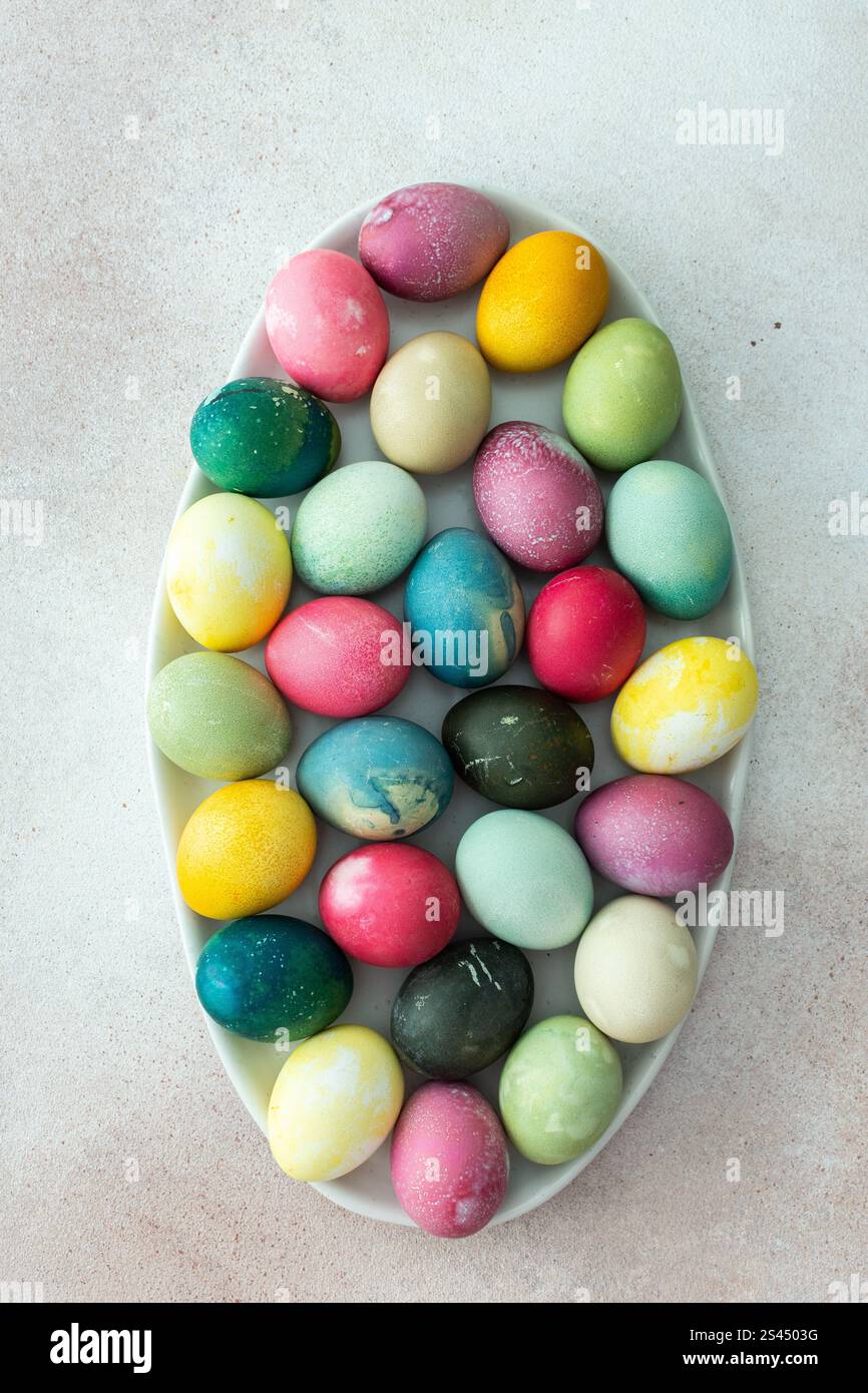 Multi-colored Easter eggs in an oval dish , top view, Happy Easter holiday Stock Photo