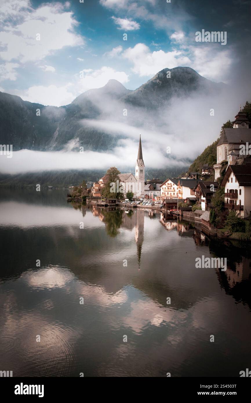 A tranquil morning in Hallstatt, Austria, captures a scene of pure serenity. The still waters of Lake Hallstatt create a mirror-like reflection' Stock Photo