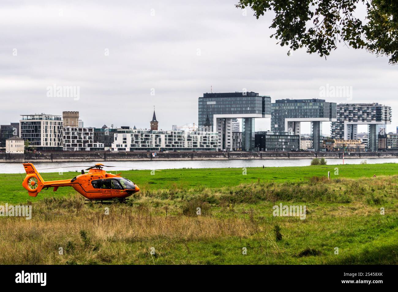 Eurocopter EC135 air ambulance (Luftrettung) helicopter on the Poller Wiesen opposite Rheinauhafen, Köln, Nordrhein-Westfalen, Germany Stock Photo