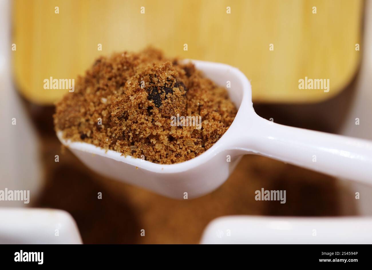 Closeup Spoon Scooping Brown Sugar for Adding in Dessert Stock Photo