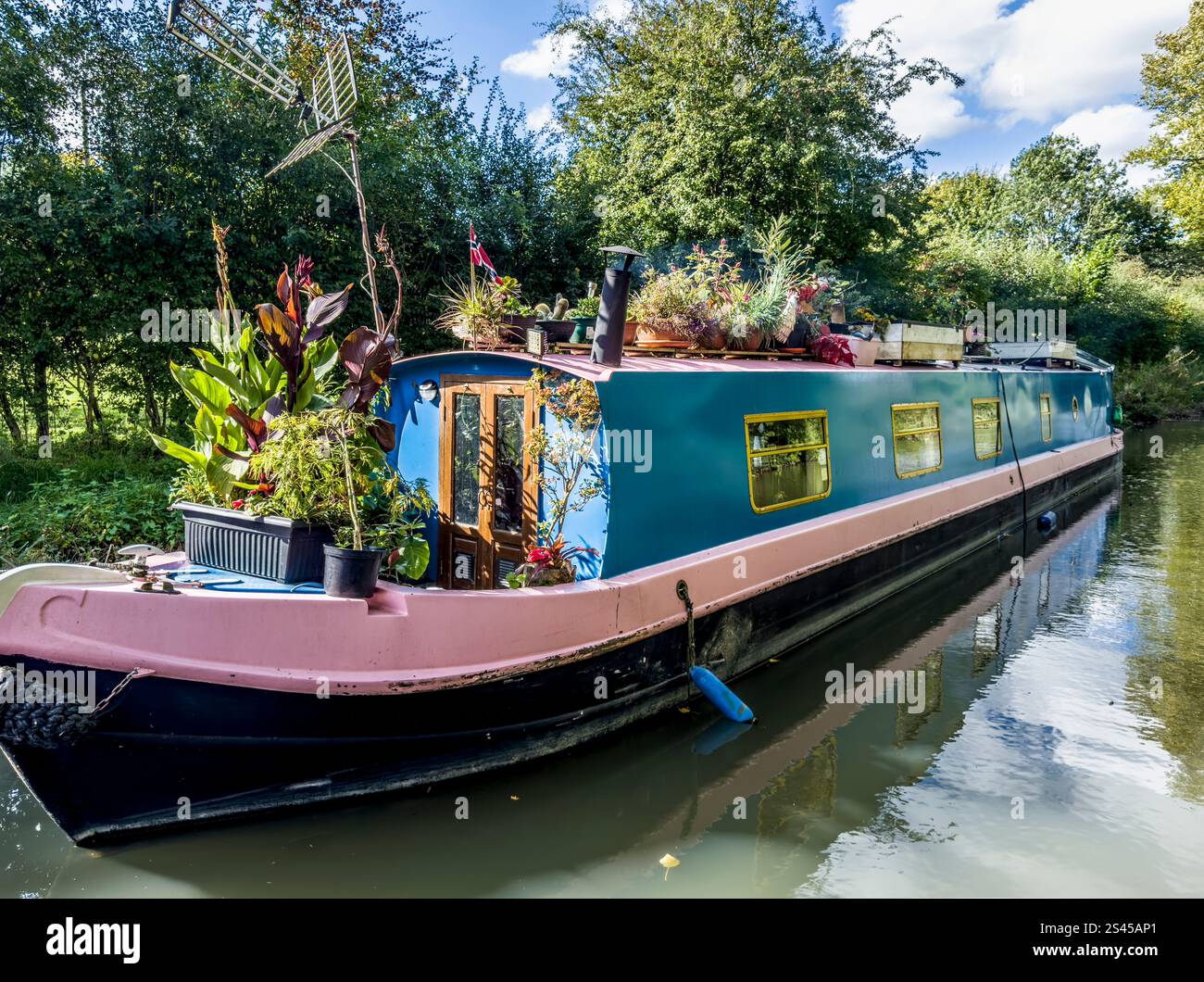 A houseboat along the Kennet and Avon Canal near Hungerford in Berkshire. - Smartphone Captured Stock Image