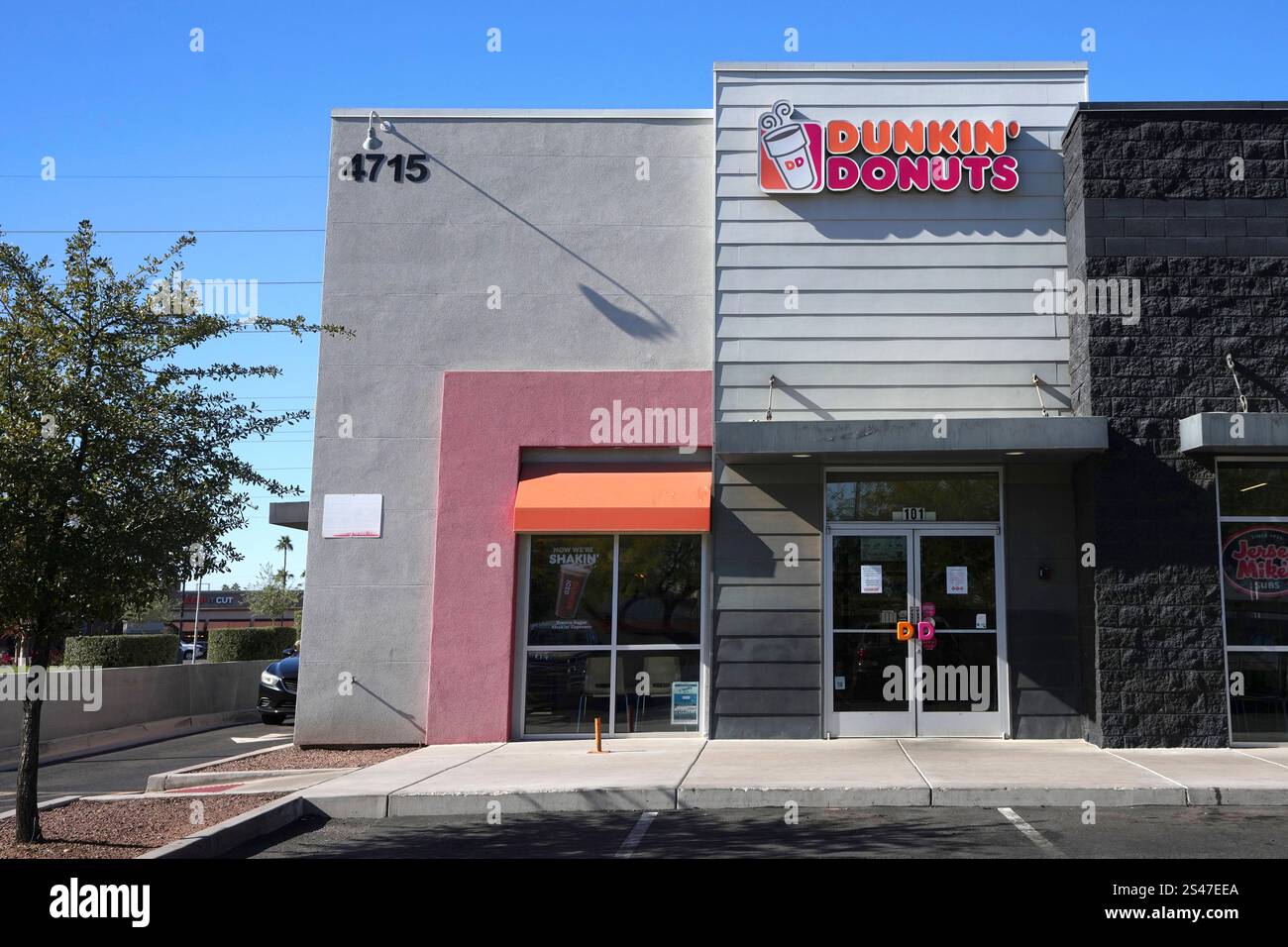 Signs on the doors of a Dunkin' Donuts restaurant explains that