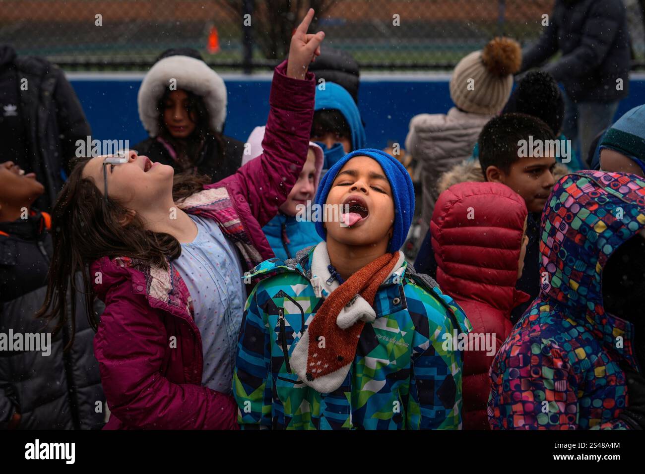 Kids catch snowflakes with their tongues during El Museo del Barrio's