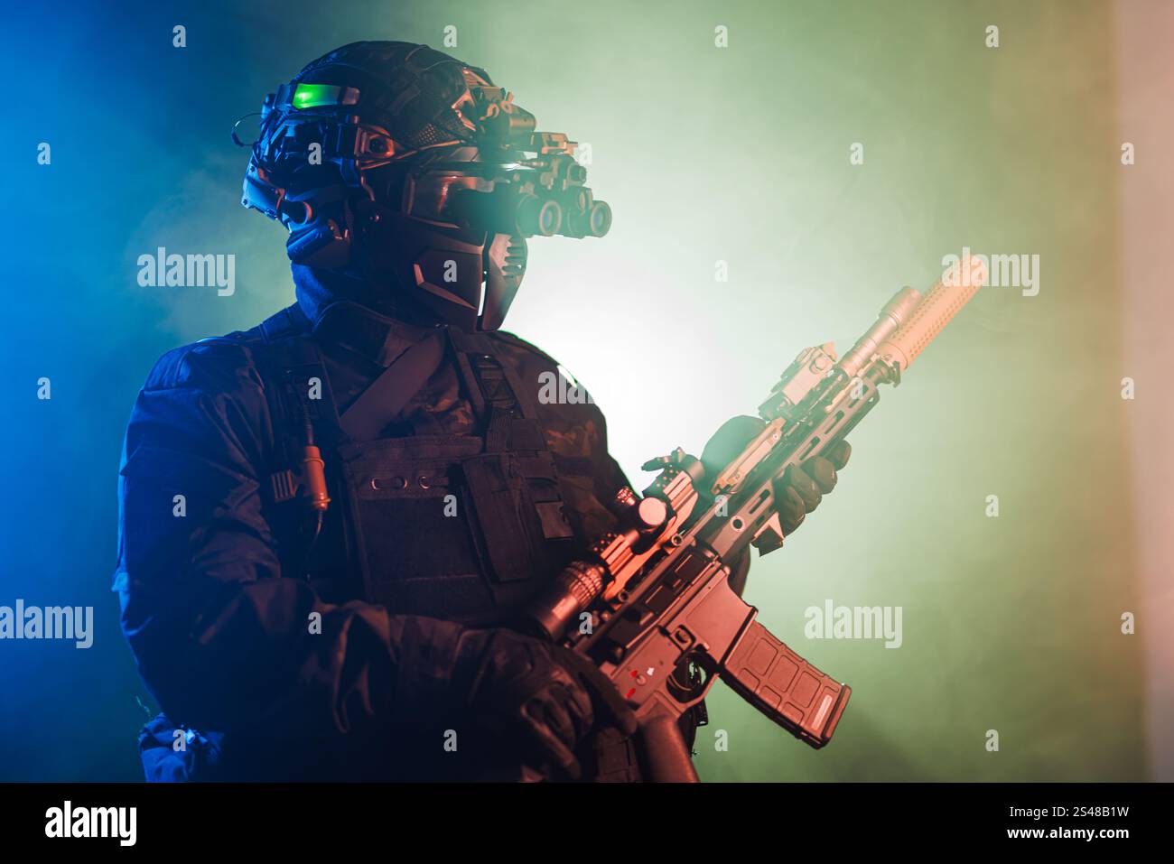 Tactical operator equipped with advanced military gear and rifle, lit ...