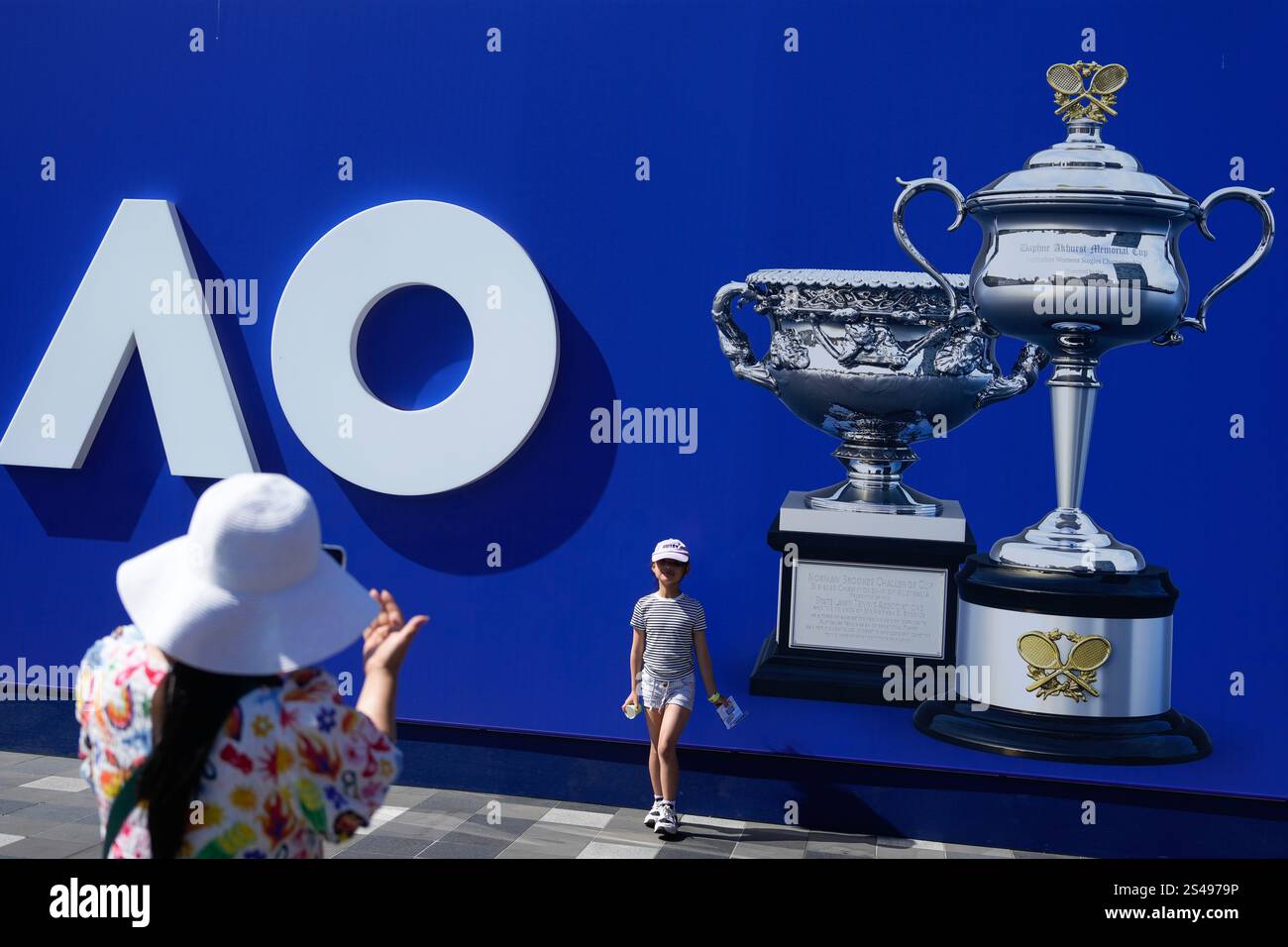 A child has their picture taken near photos of the Australian Open men
