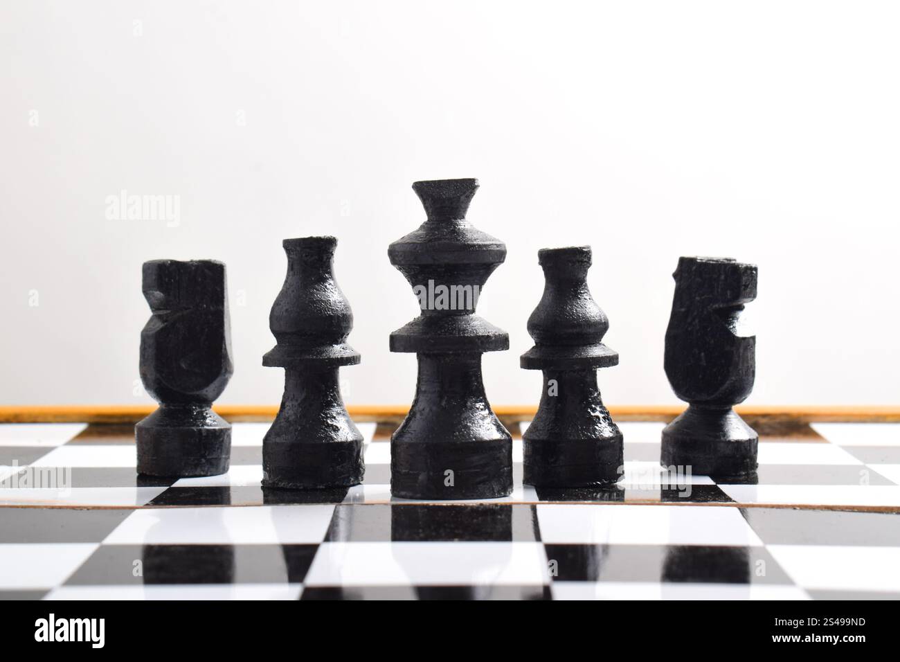 Black chess pieces set on chess board. Chess board game concept about business and competition idea and strategy plan Stock Photo