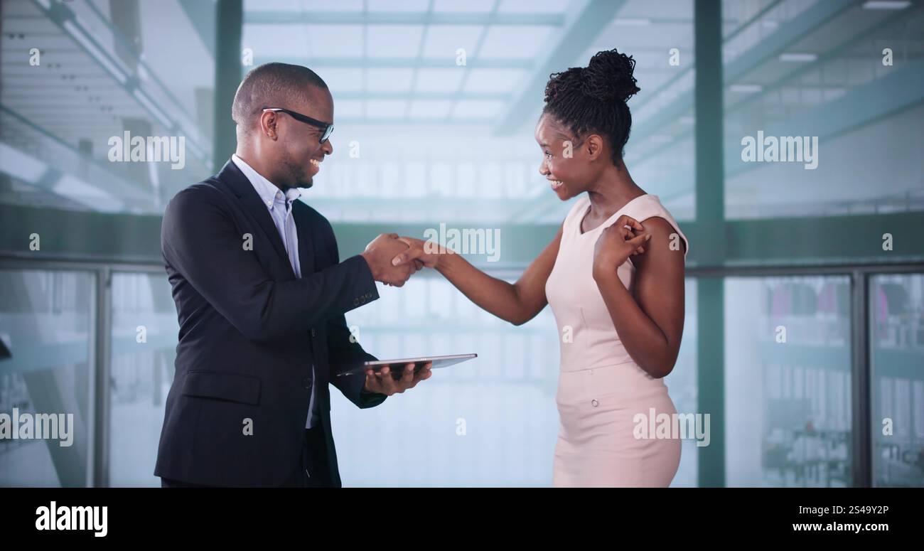 Businesspeople Discussing Standing Inside Elevator At Work Stock Photo