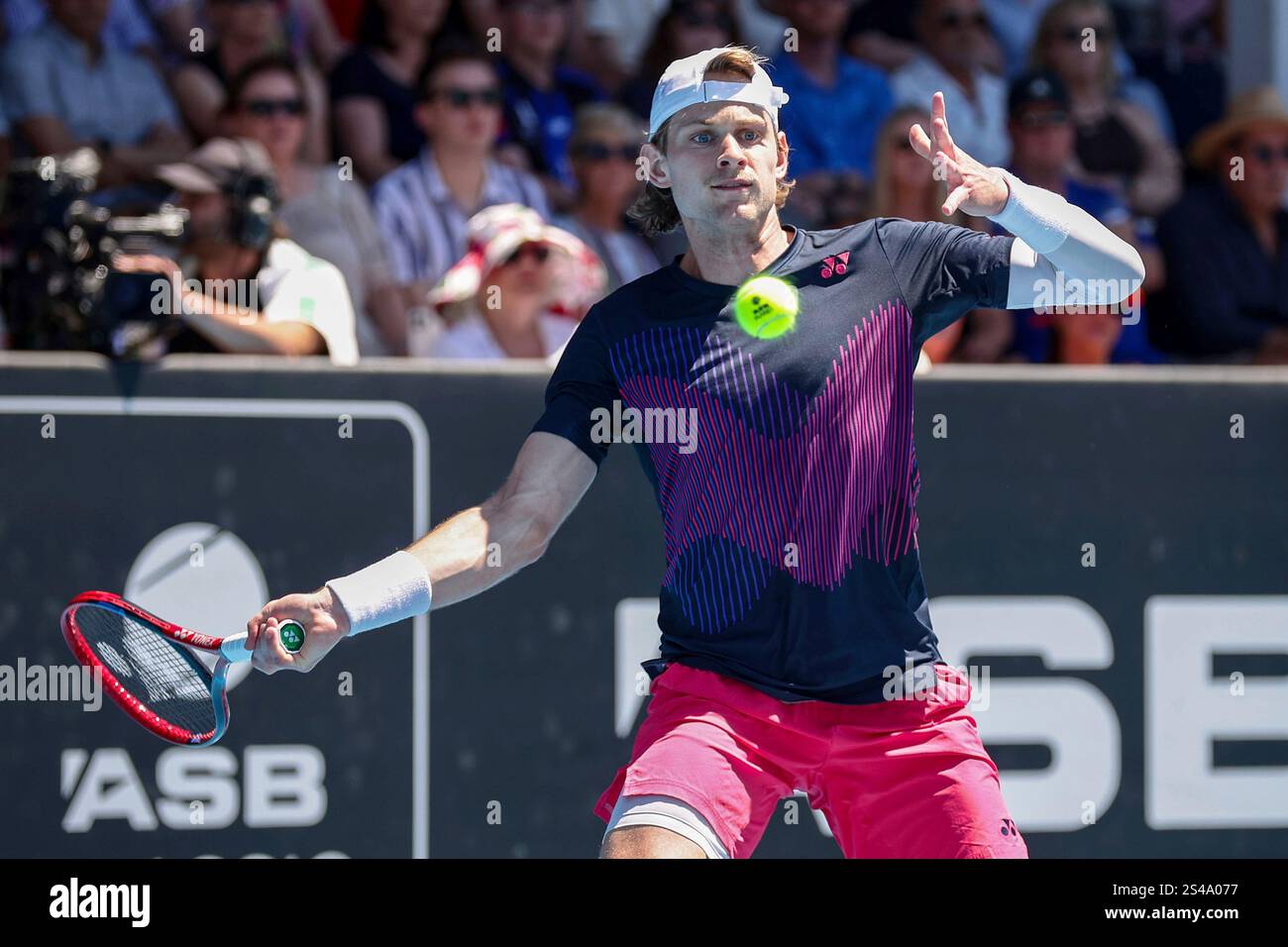 Zizou Bergs of Belgium plays a shot against Gael Monfils of France