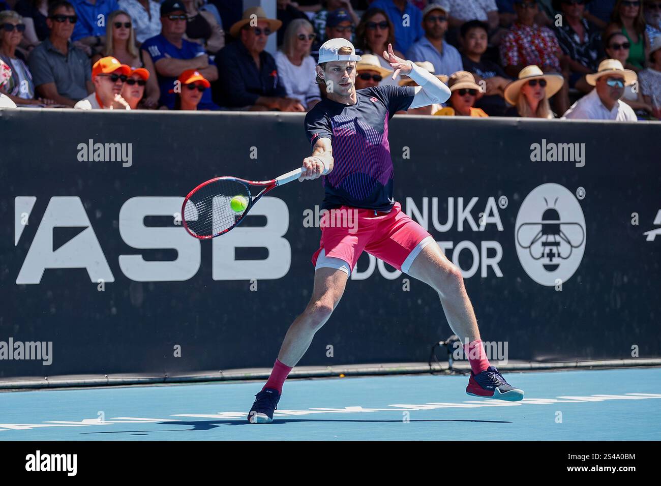 Zizou Bergs of Belgium plays a shot against Gael Monfils of France