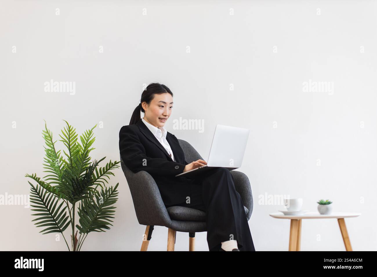 Asian female employee seated hi-res stock photography and images - Alamy