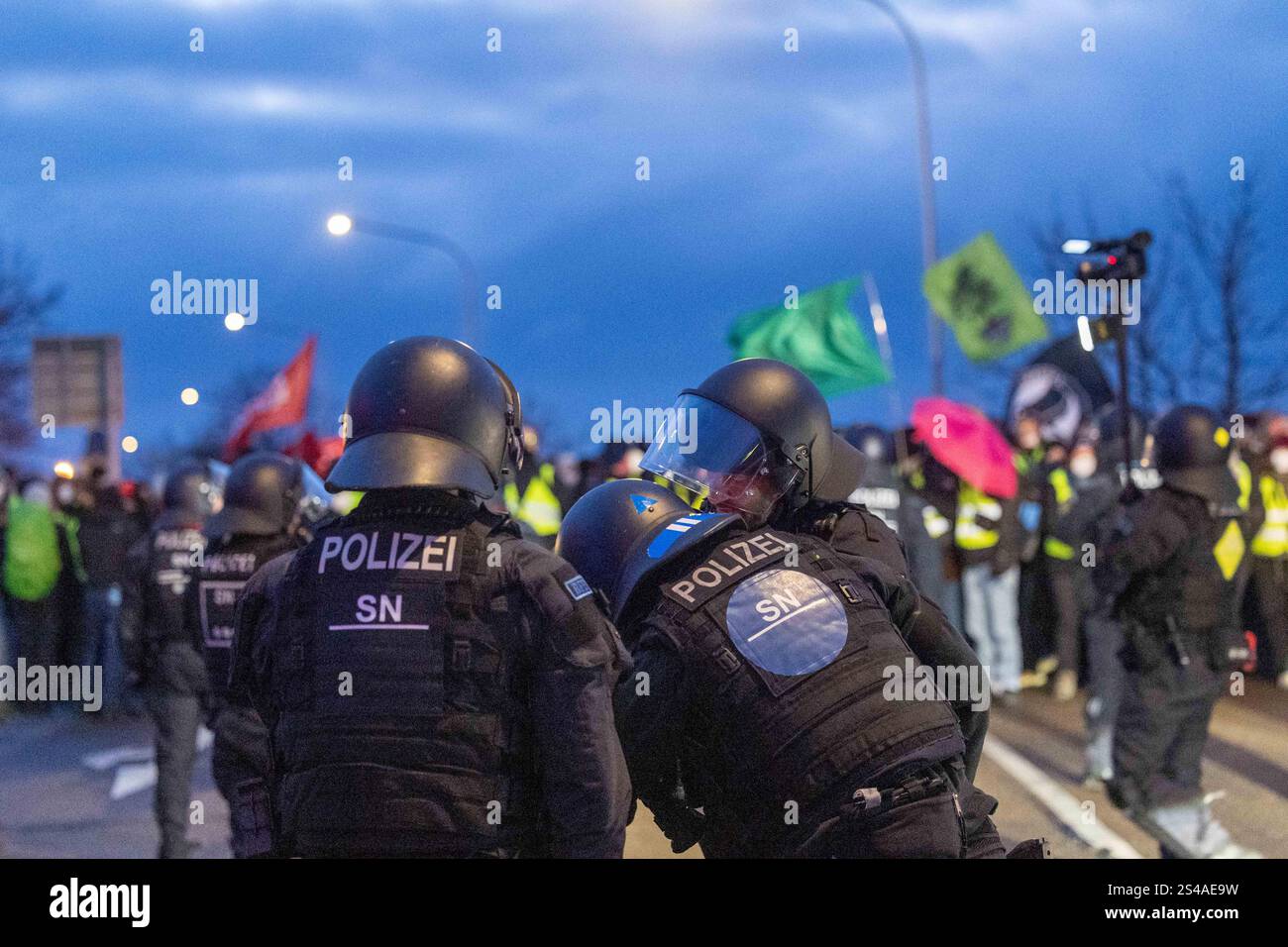 Riesa, Germany. 11th Jan, 2025. Police officers stop the protest march ...
