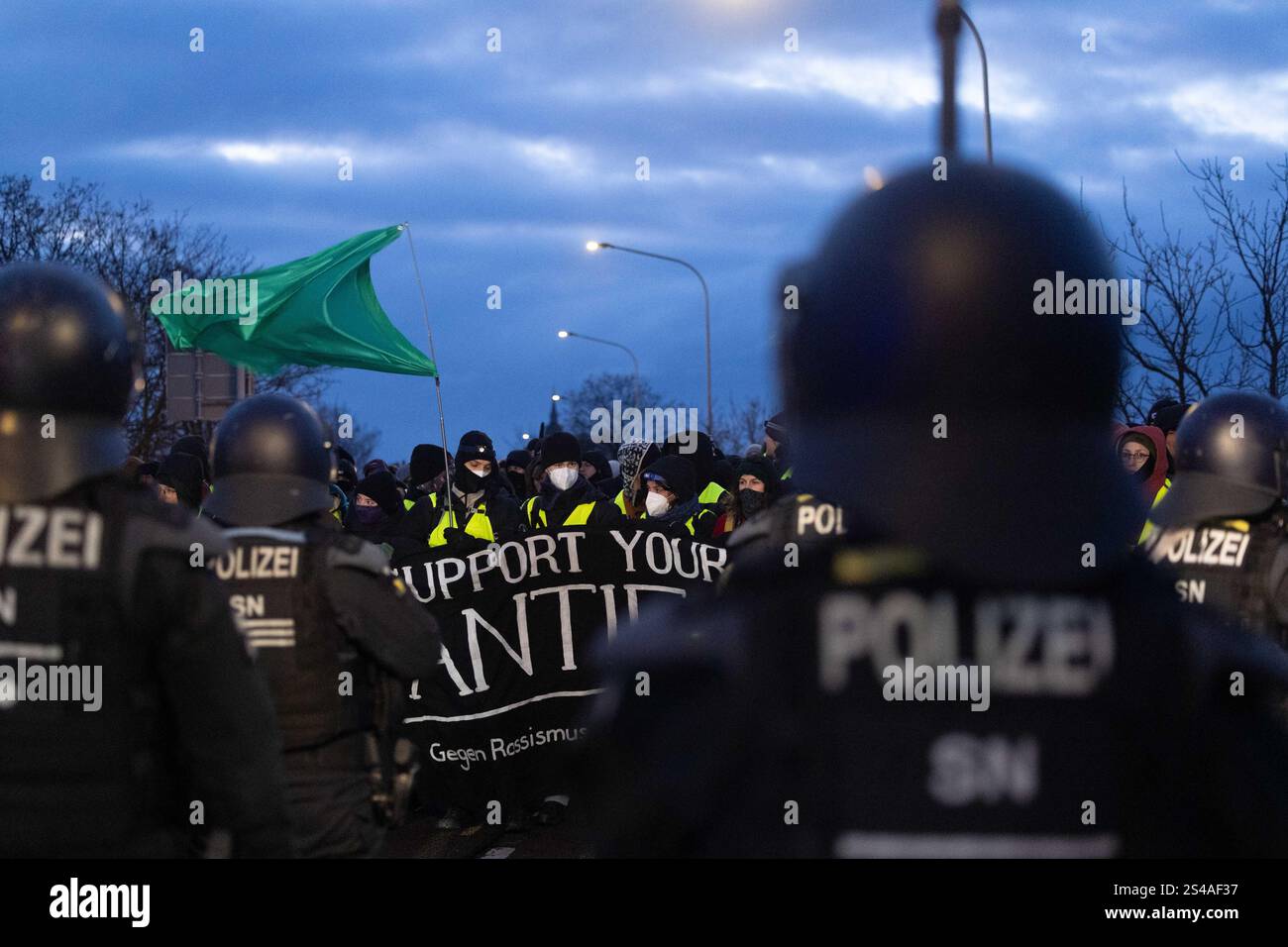 Riesa, Germany. 11th Jan, 2025. Police officers stop the protest march ...