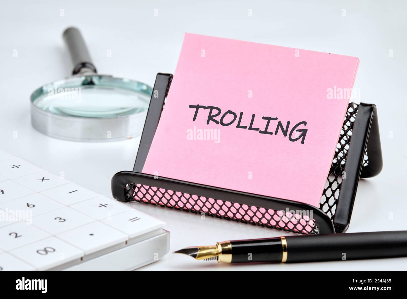 Troll Note A note labeled trolling sits in a black mesh holder on a desk ...