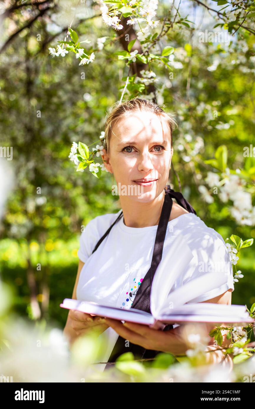 Amazing young woman posing in apple tree at spring. High quality photo ...