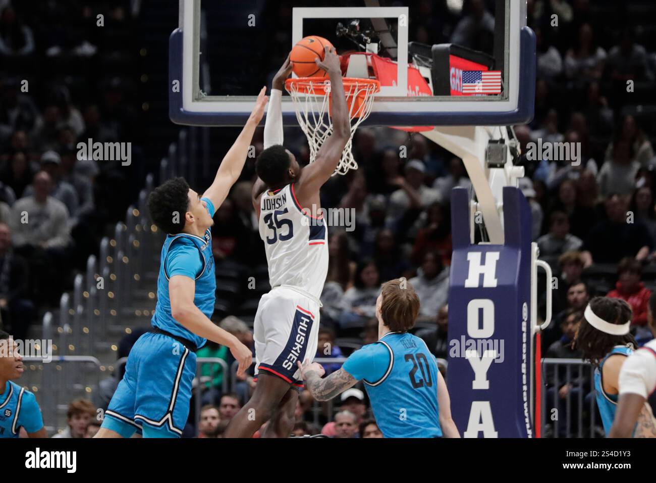 Connecticut's Samson Johnson (35) dunks the ball as Georgetown's Caleb ...