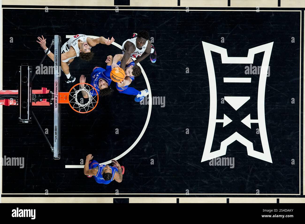 Kansas center Hunter Dickinson, lower right, rebounds against ...