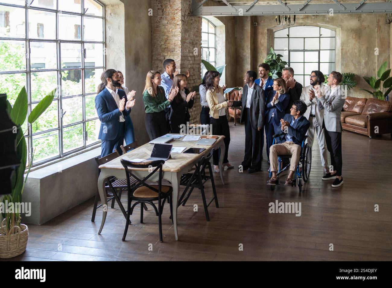 Diverse group of business professionals celebrating success with ...