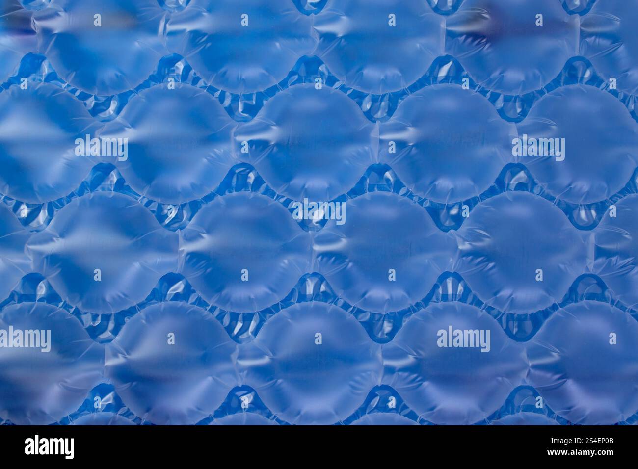 Cushions bubble wrap on blue background, abstract texture backdrop Stock Photo