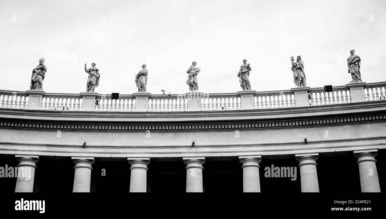 Statues on colonnades that surround St. Peter's Square in Rome Stock