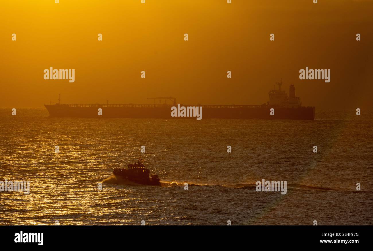 Sassnitz, Germany. 12th Jan, 2025. The unmaneuverable tanker "Eventin" is moored in the Sassnitz roadstead between Binz and Sassnitz at sunrise. The tanker, loaded with around 99,000 tons of oil, is to remain there until a decision is made on how to proceed. Credit: Stefan Sauer/dpa/Alamy Live News Stock Photo
