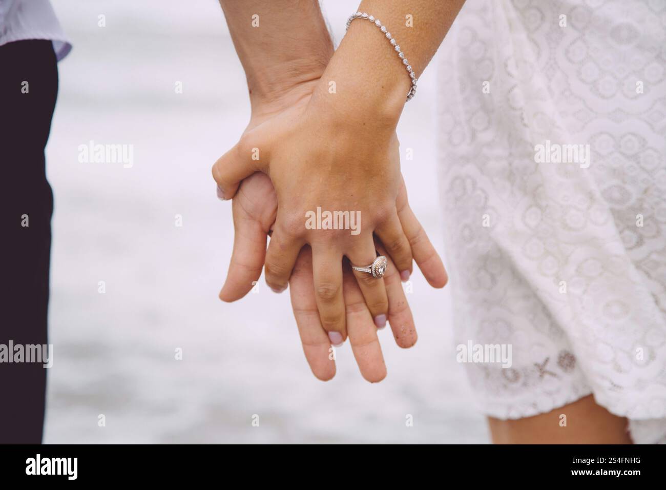 Newly wed couple hand to hand Stock Photo