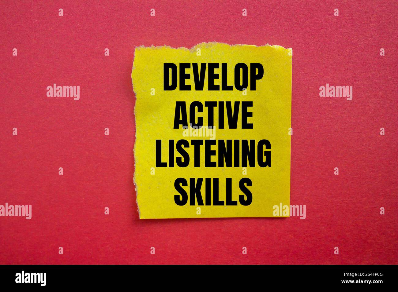 Develop active listening skills message written on ripped torn yellow ...