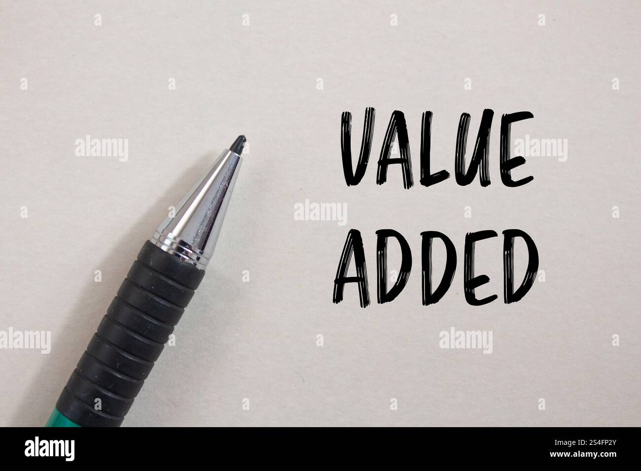 Value added message written on white paper with a pen. Conceptual value ...
