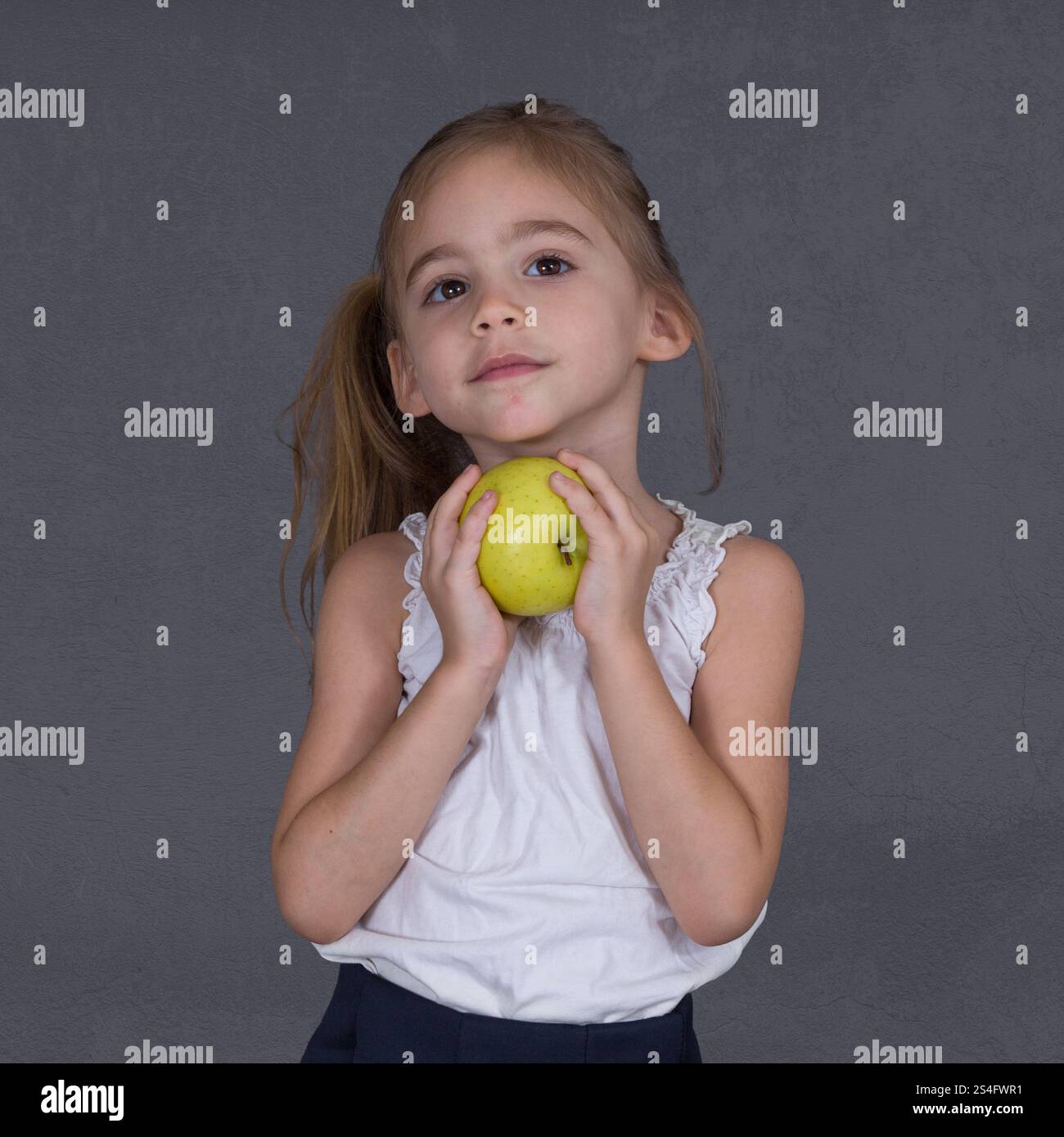 A Four year old Girl Holds An Apple Stock Photo Alamy A four year old girl holds an apple stock photo alamy