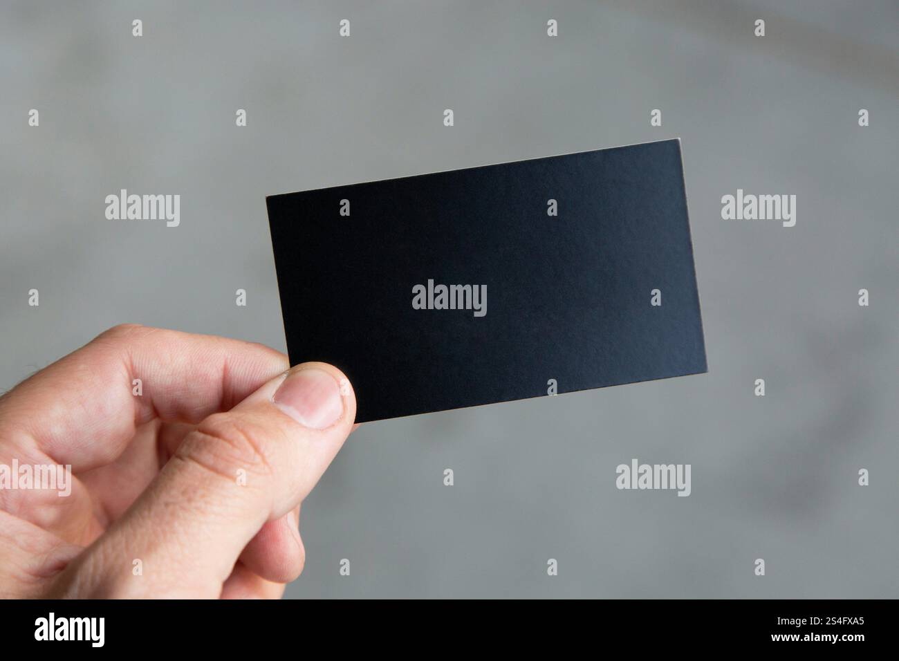 person holding black rectangular business card. Stock Photo