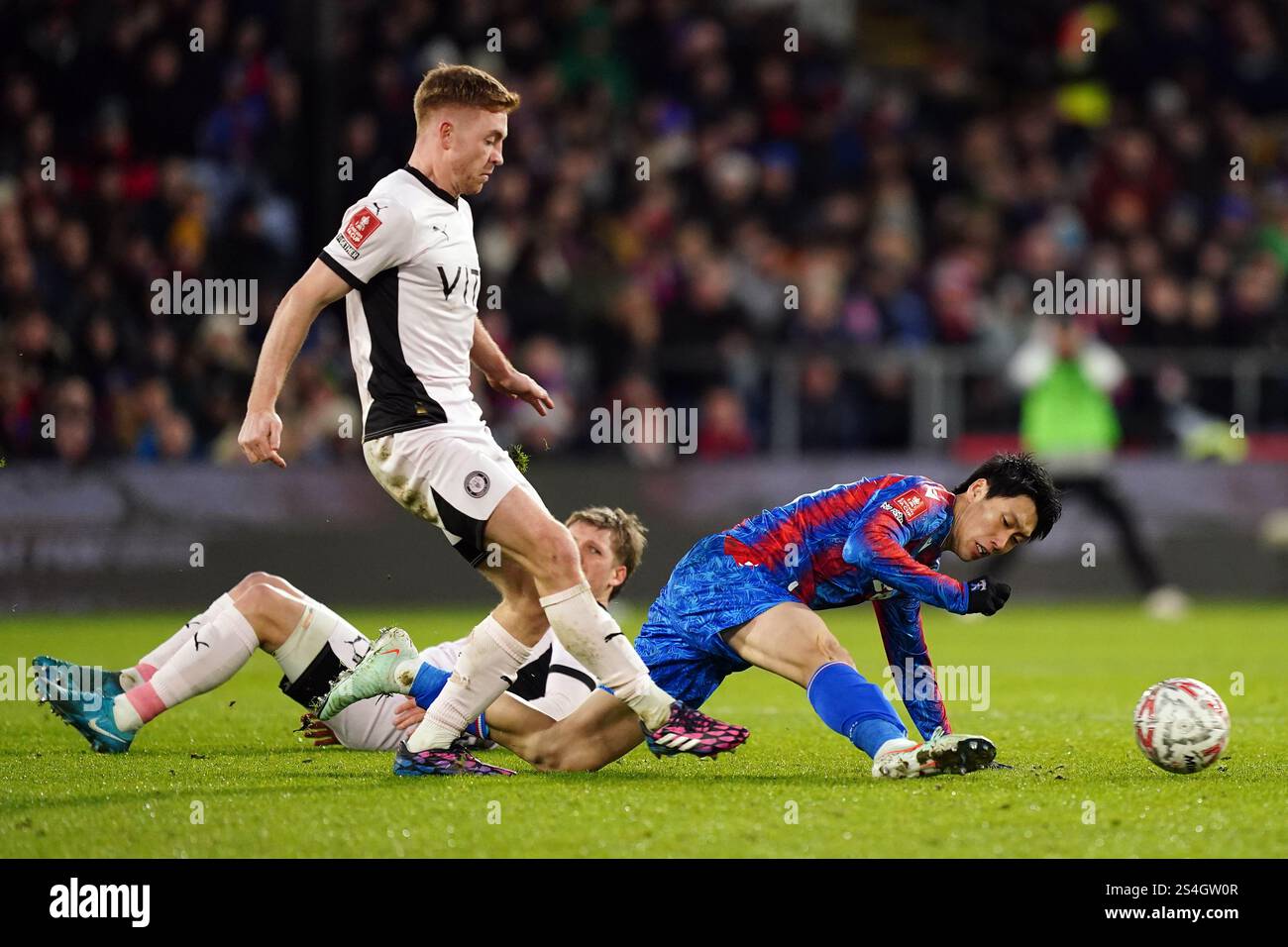 Stockport County's Callum Camps (left) and Crystal Palace's Daichi Kamada battle for the ball during the Emirates FA Cup third round match at Selhurst Park, London. Picture date: Sunday January 12, 2025. Stock Photo