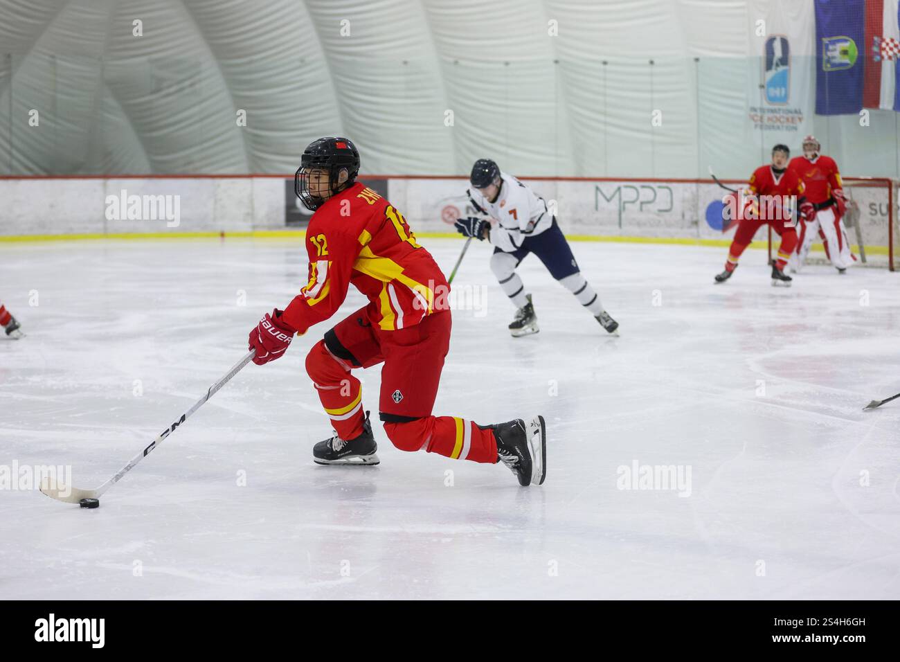 Zagreb, Croatia. 12th Jan, 2025. Zijian Zhou of China plays the puck ...