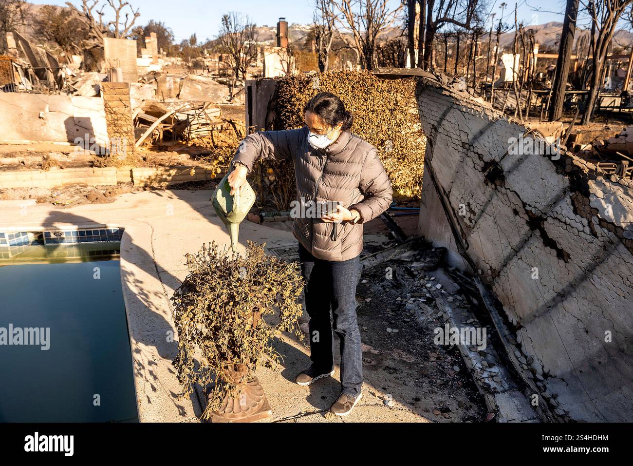 Marjan Rajabi Marjan Rajabi waters a scorched plant at her Pacific Palisades home ...
