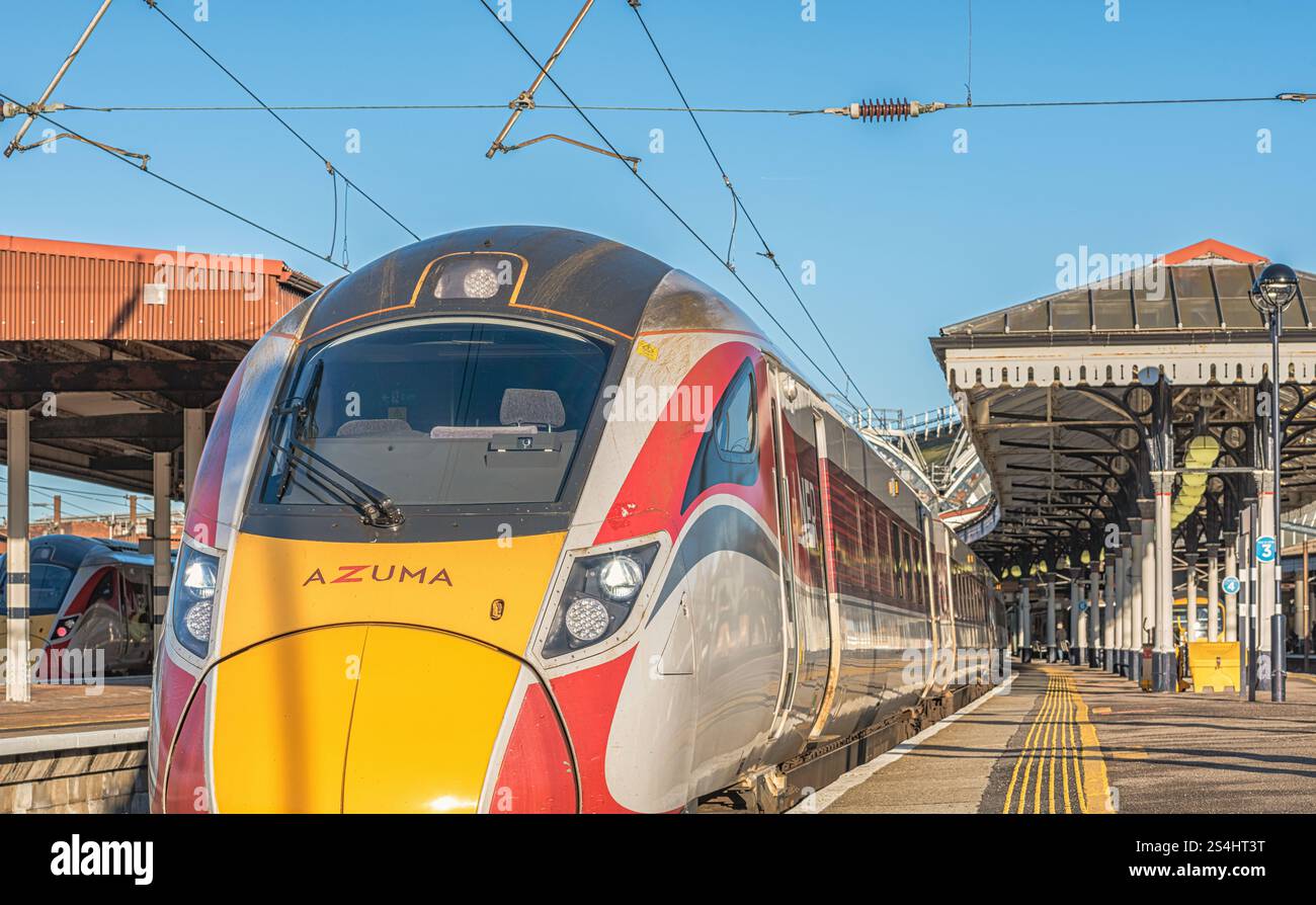 Train Columm A railway train is stationary at a historic railway station platform ...
