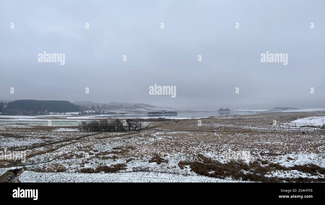 Open wide Scottish landscape in the winter. Snow and frost on the ground and in the distance, the Ballo Reservoir in Glen Vale, Scotland - Smartphone Captured Stock Image